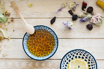 Autumn hot herbal tea with honey, cinnamon and lemon. Top view. Image toned.