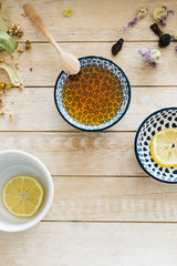 Autumn hot herbal tea with honey, cinnamon and lemon. Top view. Image toned.