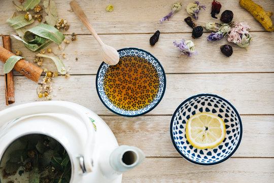 Autumn hot herbal tea with honey, cinnamon and lemon. Top view. Image toned.
