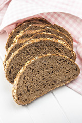 Sliced whole grain bread with oat flakes. Wholemeal bread.