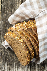 Sliced whole grain bread with oat flakes. Wholemeal bread.