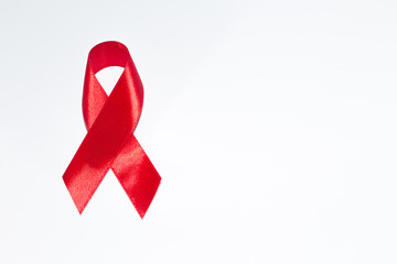 Red ribbon on a white isolated background is the symbol of World AIDS Day.