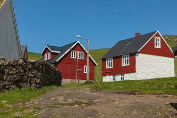 Beautiful village of Mykines with colorful houses with grass on the roofs, Mykines island, Faroe Islands, Europe.