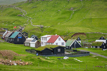 Obraz premium Beautiful village of Mykines with colorful houses with grass on the roofs, Mykines island, Faroe Islands, Europe.