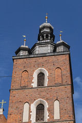 Fototapeta premium Architectural fragments of Brick Gothic St. Mary's Basilica (Church of Our Lady Assumed into Heaven or Kosciol Mariacki). Built in early XIII century Church is main landmark of city. Kracow, Poland.