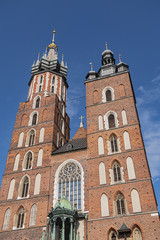 Fototapeta na wymiar Architectural fragments of Brick Gothic St. Mary's Basilica (Church of Our Lady Assumed into Heaven or Kosciol Mariacki). Built in early XIII century Church is main landmark of city. Kracow, Poland.