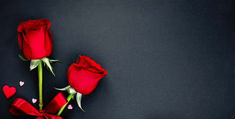 Beautiful valentines day background with red roses and hearts on black background. Flat lay, Copy...