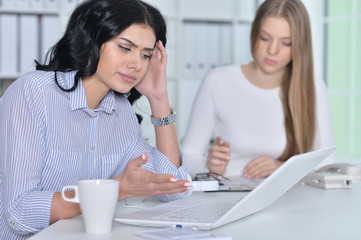 Close up portrait of two young girls working