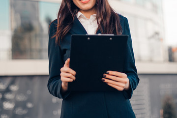 Successful smile businesswoman or entrepreneur standing in front of his office.