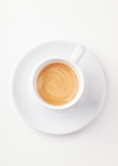 Cup of coffee isolated on white paper background. Top view. 