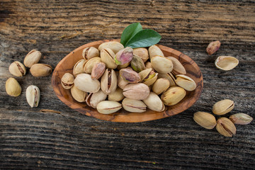 Pistachios on a wooden table.