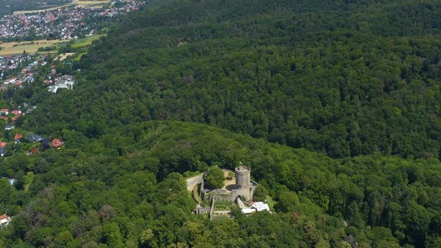 Aerial view of the castle Schloss Alsbach in Germany. On a sunny day in Summer. Wide view with pan to the left around the castle.