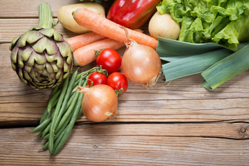 Assorted fresh vegetables on wooden background, top view, space for text.