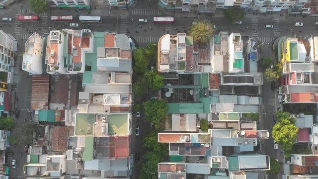 a flying camera flies over the roofs of Vietnamese slums and houses, overlooking the road and predizayuschie cars, different angles, view from top to bottom.