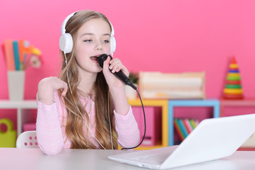 Close up portrait of cute girl singing karaoke