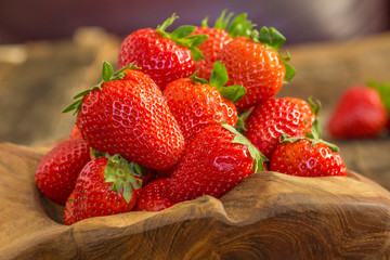 Strawberries in wooden bowl. Fresh nice strawberries on wooden table.