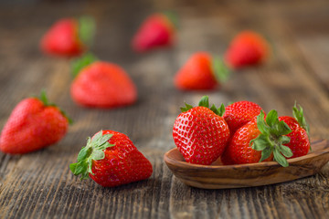 Strawberries in wooden bowl. Fresh nice strawberries on wooden table.