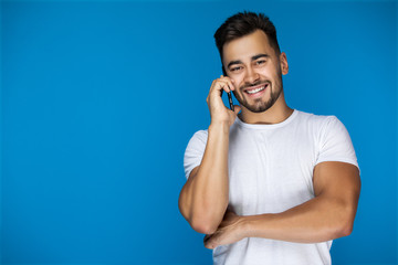 handsome european guy on the blue backgroud is calling