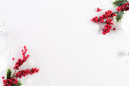 Christmas Background Concept. Top View Of Christmas Ball With Snowflakes And Red Berries On White Background.