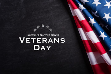 Fototapeta na wymiar Happy Veterans Day. American flags veterans against a blackboard background.