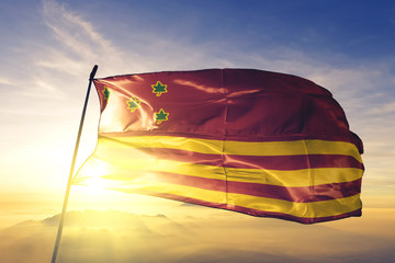 Ilheus of Brazil flag waving on the top sunrise mist fog