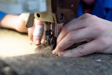 Sewing details of fur and leather. Shoe production.
