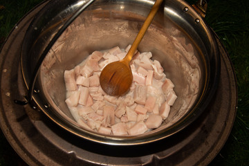 fried bacon in a stainless steel pan