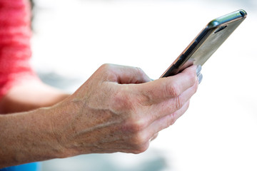 older woman hands holding mobile phone