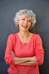 attractive middle aged woman laughing with arms crossed