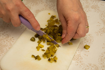 Housewife hands cutting pickles cucumbers 
