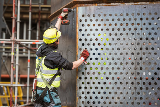 Blue color worker bolts screwed to the structure on site