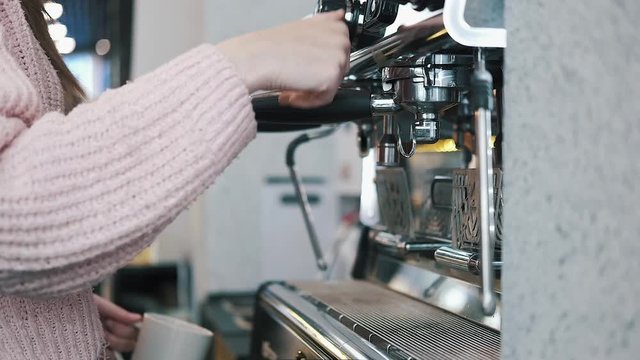 Fresh Black Coffee Pouring from Professional Machine Dispenser in Cup. 4K, Macro Slowmotion.