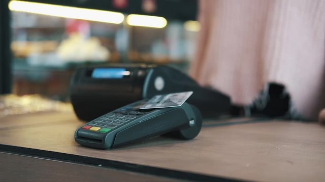 Concept contactless payment. Making payment with credit card and pos terminal, printed check.