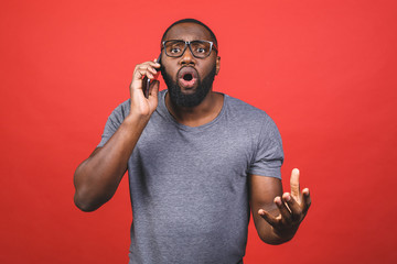 Young handsome man talking on the phone cover mouth with hand shocked with shame for mistake, expression of fear, scared in silence, secret concept. Isolated over red background. - obrazy, fototapety, plakaty