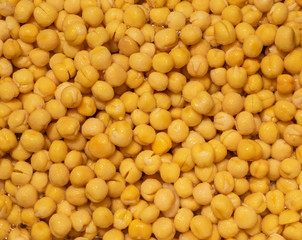 close up of soaked yellow peas in water.