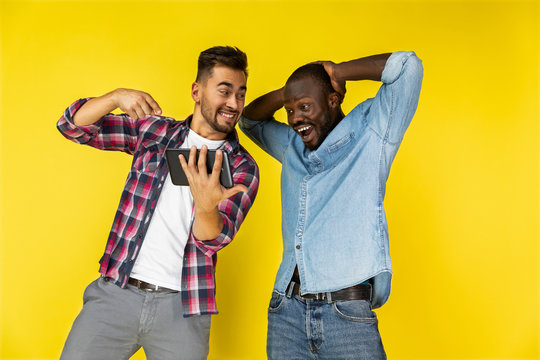 European and black man delighted of watching the tablet