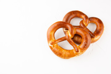Pretzels with salt on white background top view. Copy space