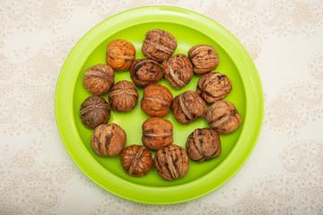 Fototapeta na wymiar nuts on a green plate