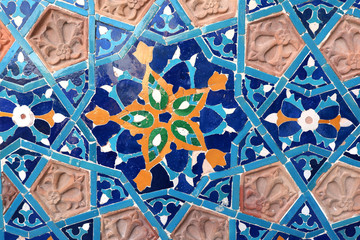 Detail of old mosaic wall with traditional georgian floral pattern with clay and ceramic details of red, yellow and blue colors