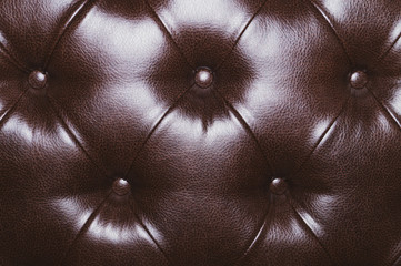 Leather upholstery texture of sofa. brown couch close up background