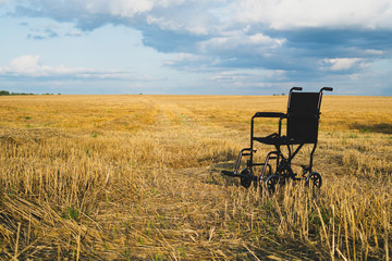 Empty wheelchair in a wide meadow. disabled carriage in nature. medical equipment for invalid person