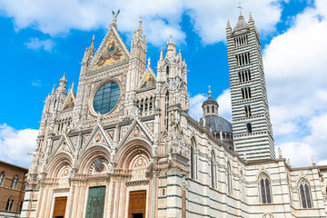 Fototapeta na wymiar Scenery of Siena, a beautiful medieval town in Tuscany, with view of the Dome & Bell Tower of Siena Cathedral (Duomo di Siena), landmark Mangia Tower and Basilica of San Domenico,Italy