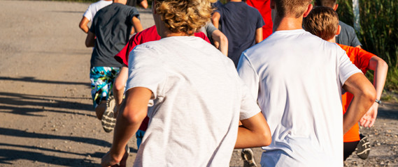 Fototapeta premium Group of runners running on a dirt path