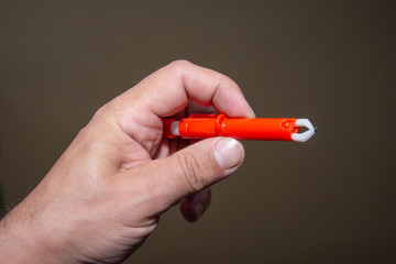Red  Extractor for removing ticks,TICK TWISTER in a hand