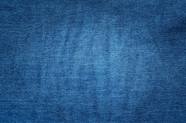 Dark fabric background. Dark blue jeans texture.