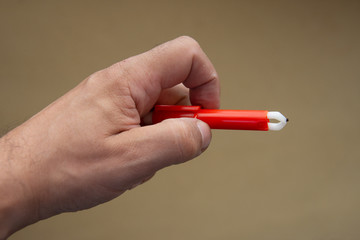 Red  Extractor for removing ticks,TICK TWISTER in a hand
