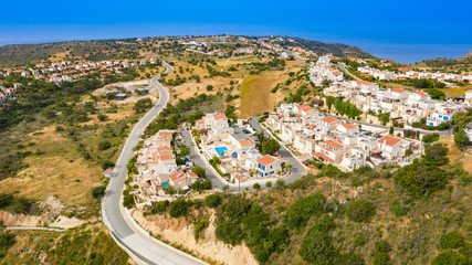 Fototapeta na wymiar Panorama Cyprus. Pissouri village, near the mountains with drone. The road near the village. Houses and streets of the village Pissouri. Mediterranean. Pissouri Resort. Travelling to Cyprus.