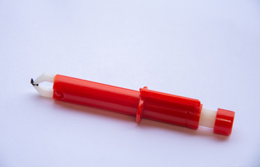 Red  Extractor for removing ticks,TICK TWISTER in a hand