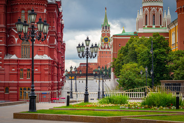 Fototapeta na wymiar Moscow. Exit to Red square. Kremlin. Mausoleum. Buildings of red stone in the capital of Russia. Red square is empty. Spasskaya tower of the Kremlin on the background of gray clouds.
