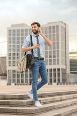 Handsome man talking on phone in modern city